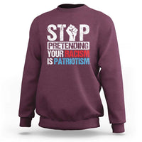 Maroon crewneck sweatshirt with bold front 'STOP' graphic and slogan