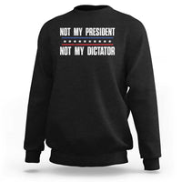Black crewneck sweatshirt with “Not My President / Not My Dictator” front graphic