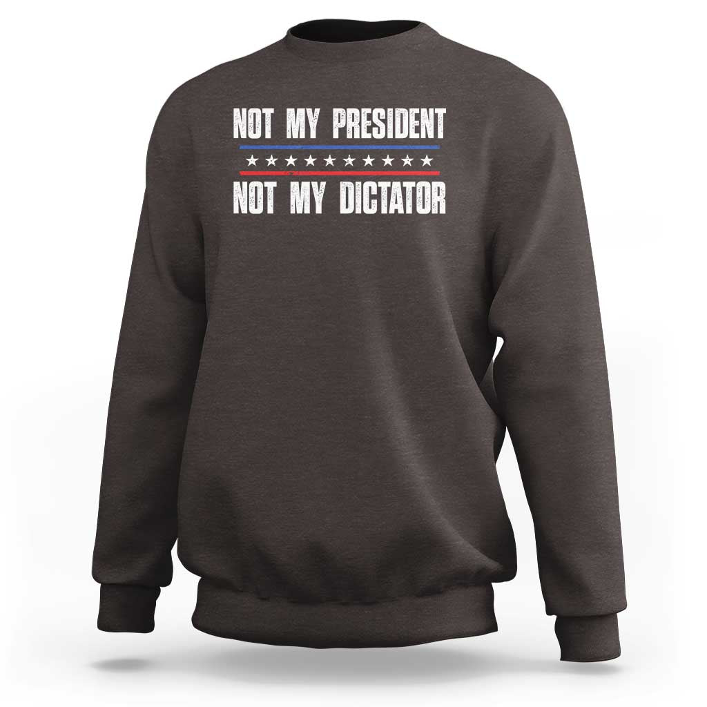 Dark brown crewneck sweatshirt with “Not My President / Not My Dictator” front graphic