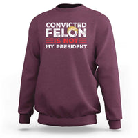 Maroon crewneck graphic sweatshirt with “CONVICTED FELIN IS NOT MY PRESIDENT” print