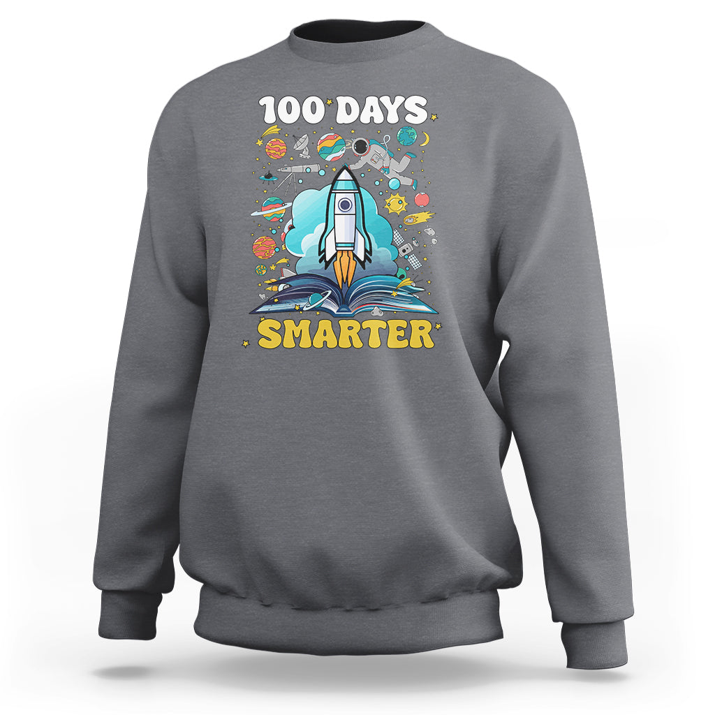 Charcoal gray crewneck sweatshirt with "100 DAYS" and "SMARTER" space rocket graphic