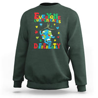 Dark forest green crewneck sweatshirt with colorful autism awareness text and puzzle graphic
