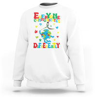 White crewneck sweatshirt with colorful autism awareness text and puzzle graphic