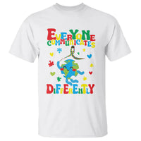 White autism awareness T-shirt with rainbow figure 'Everyone communicates differently' graphic