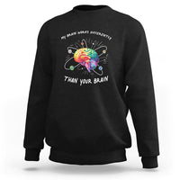 Black autism awareness sweatshirt with colorful brain graphic and slogan on chest