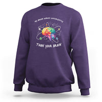 Purple autism awareness sweatshirt with colorful brain graphic and slogan on chest