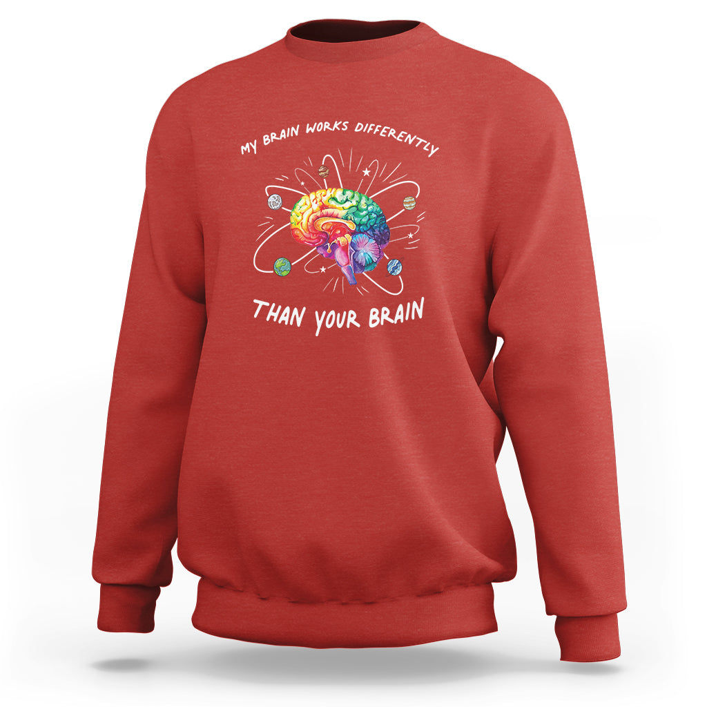 Red autism awareness sweatshirt with colorful brain graphic and slogan on chest