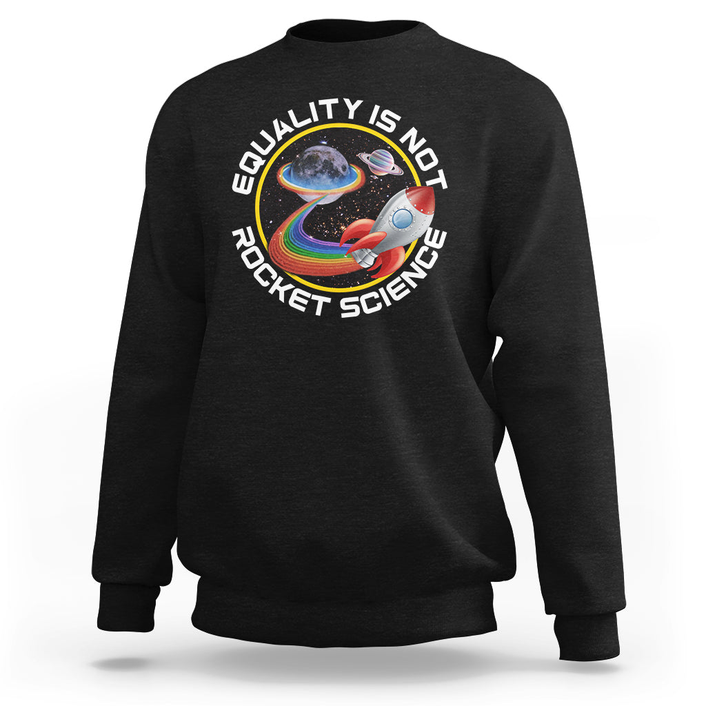 Black crewneck sweatshirt with colorful rainbow planet graphic and “Equality is no Rocket Science” text