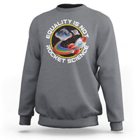 Charcoal crewneck sweatshirt with colorful rainbow planet graphic and “Equality is no Rocket Science” text