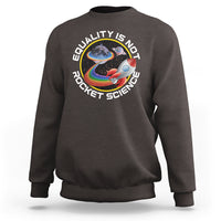 Dark chocolate crewneck sweatshirt with colorful rainbow planet graphic and “Equality is no Rocket Science” text
