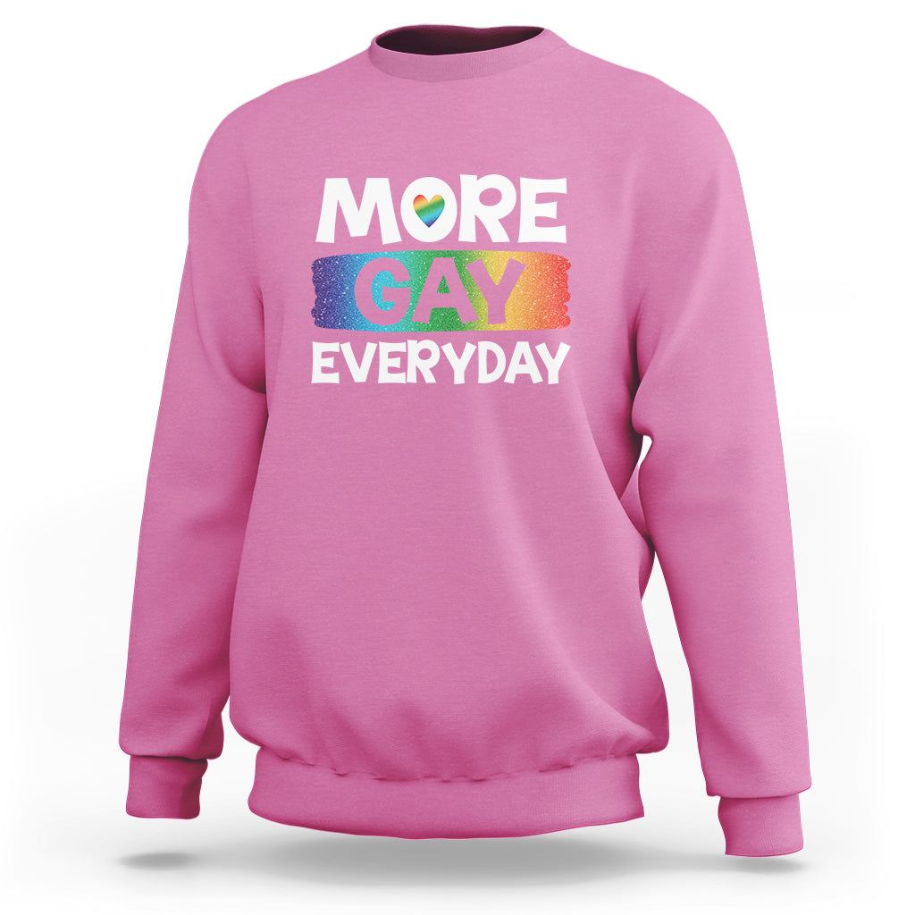 Pink sweatshirt with “MORE GAY EVERYDAY” pride graphic on the front.
