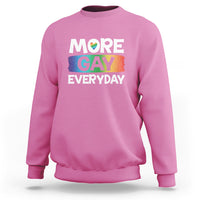Pink sweatshirt with “MORE GAY EVERYDAY” pride graphic on the front.