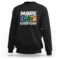 Black sweatshirt with “MORE GAY EVERYDAY” pride graphic on the front.