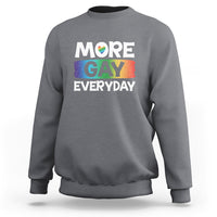 Gray sweatshirt with “MORE GAY EVERYDAY” pride graphic on the front.