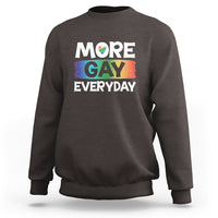 Charcoal gray sweatshirt with “MORE GAY EVERYDAY” pride graphic on the front.