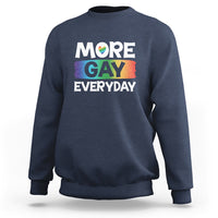 Navy blue sweatshirt with “MORE GAY EVERYDAY” pride graphic on the front.