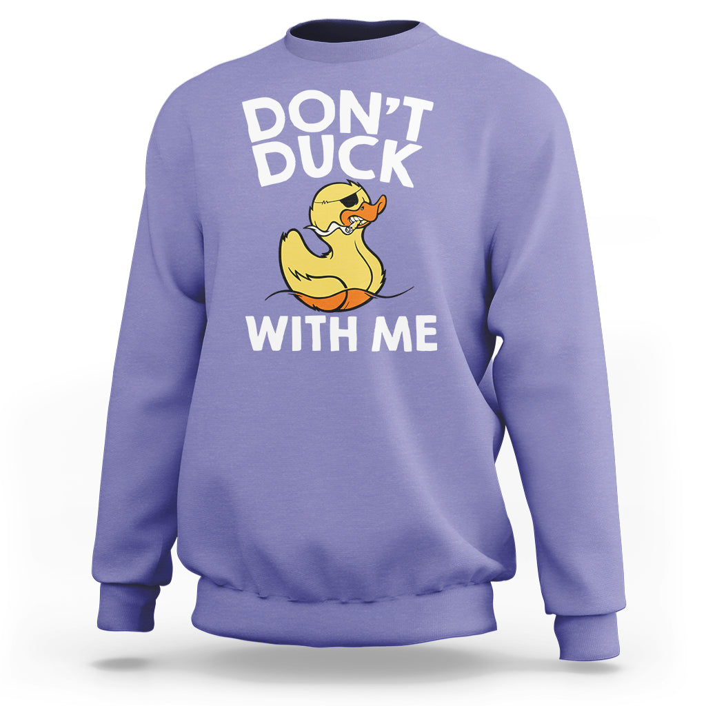 Lavender sweatshirt featuring “DON’T DUCK” and “WITH ME” text with a yellow rubber duck