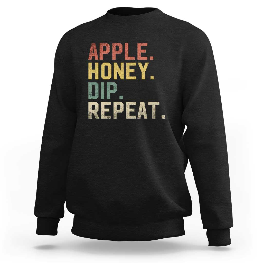 Rosh Hashanah sweatshirt in black with “APPLE HONEY DIP REPEAT” graphic