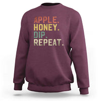 Rosh Hashanah sweatshirt in maroon with “APPLE HONEY DIP REPEAT” graphic