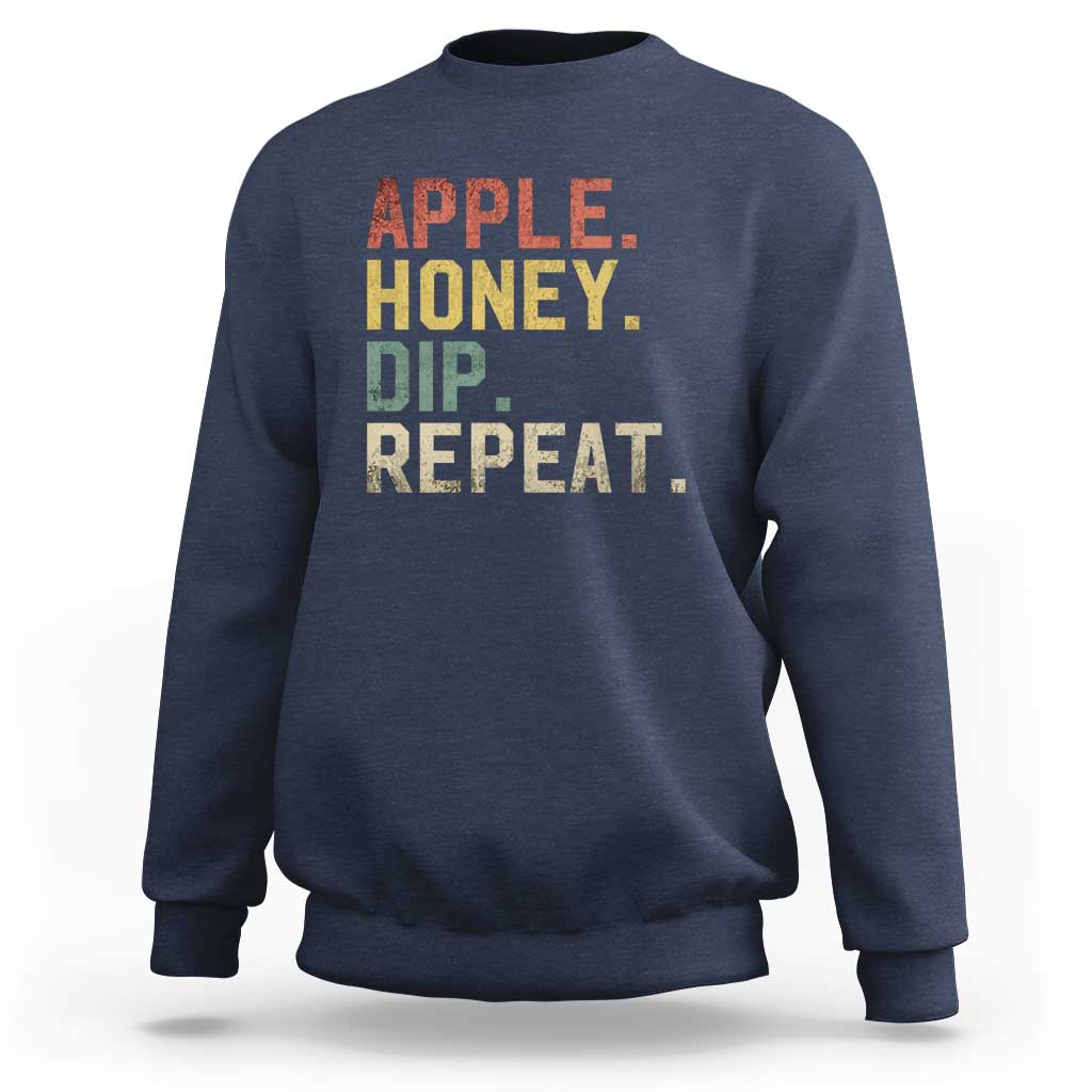 Rosh Hashanah sweatshirt in navy with “APPLE HONEY DIP REPEAT” graphic