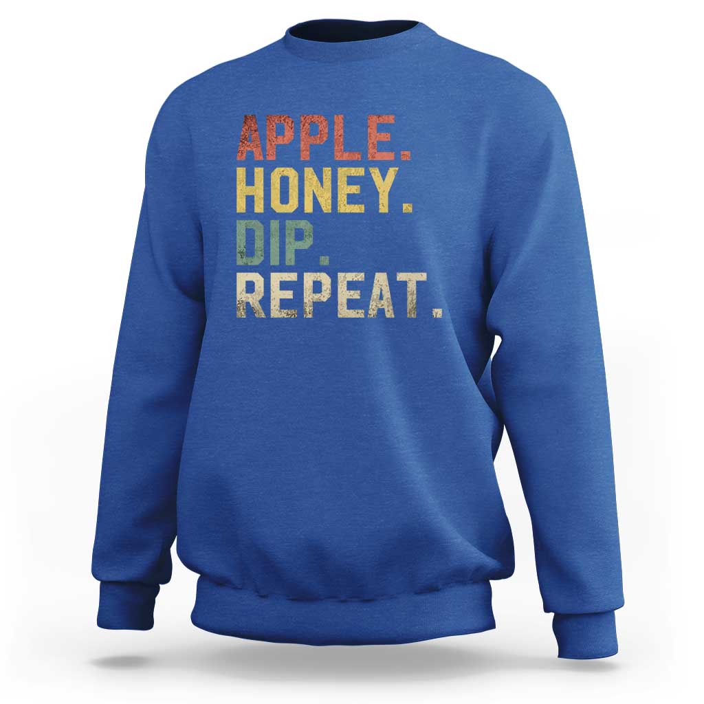 Rosh Hashanah sweatshirt in royal blue with “APPLE HONEY DIP REPEAT” graphic
