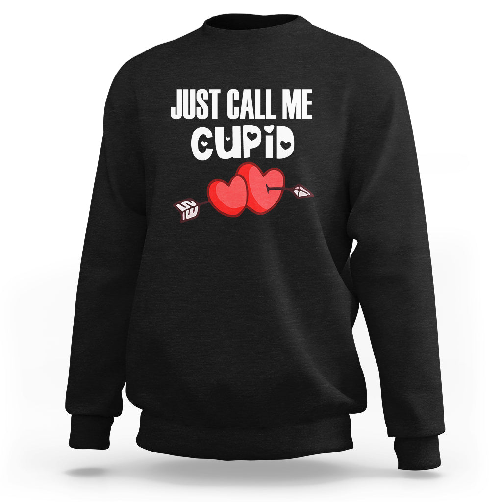 Black crewneck sweatshirt with “JUST CALL ME CUPID” text and red heart-arrow graphic