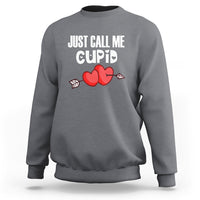 Charcoal gray crewneck sweatshirt with “JUST CALL ME CUPID” text and red heart-arrow graphic
