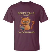Maroon crewneck T-shirt with orange cat "Don't talk" and "I'm counting" graphic
