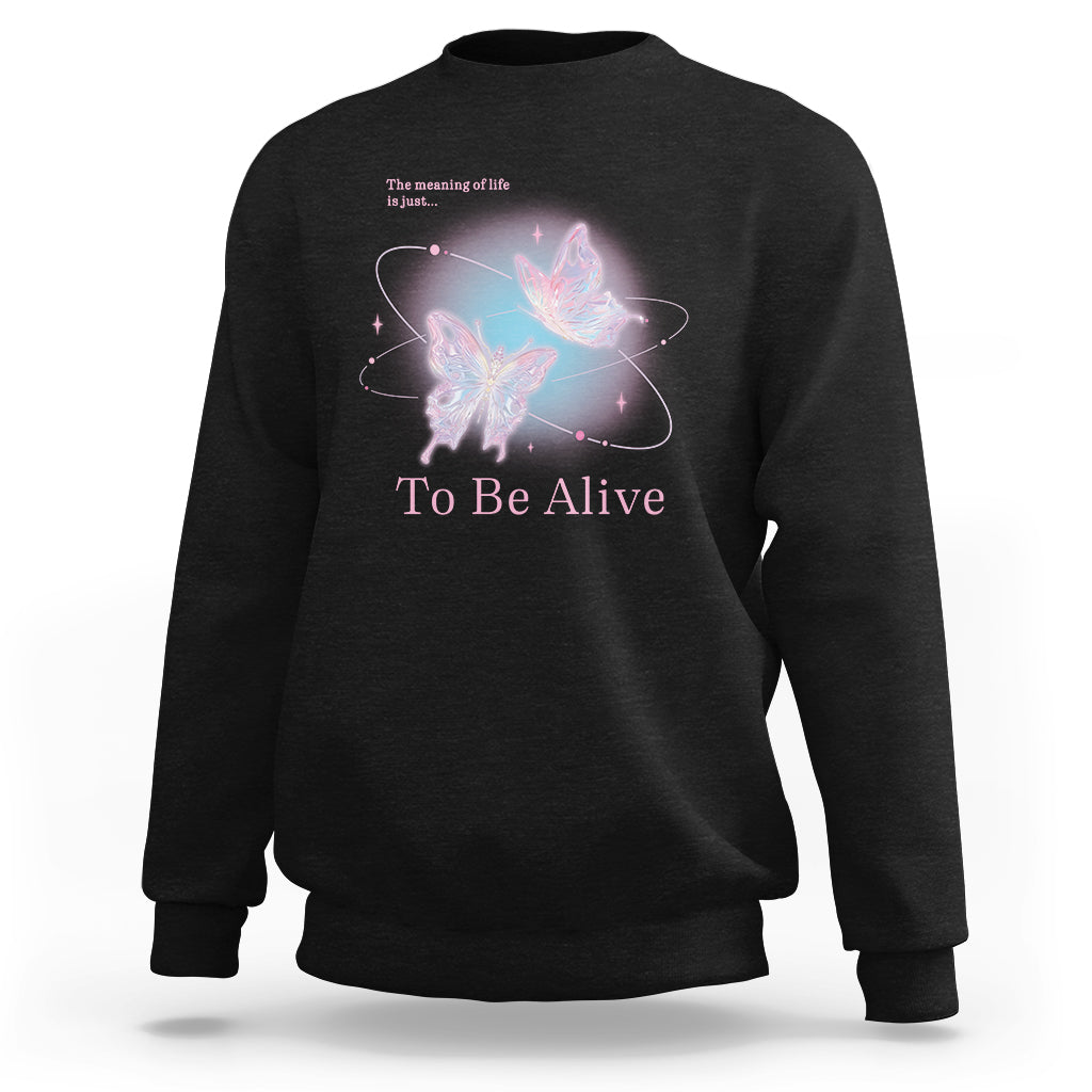 Black crewneck sweatshirt with colorful butterfly graphic and “To Be Alive” text