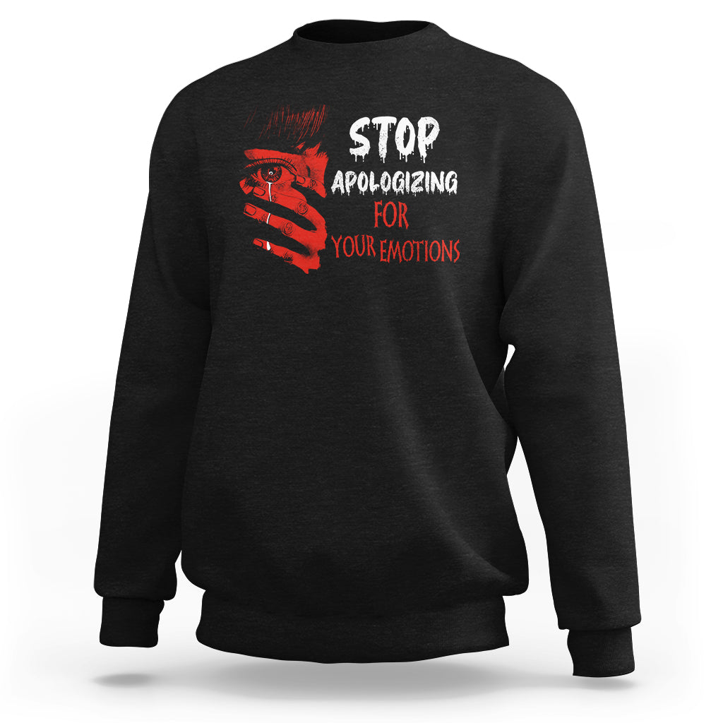 Black sweatshirt with red 'STOP APOLOGIZING FOR YOUR EMOTIONS' front graphic