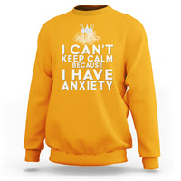 Gold sweatshirt with white 'I can't keep calm because I have anxiety' quote and crown