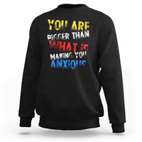 Black crewneck sweatshirt with colorful front slogan graphic