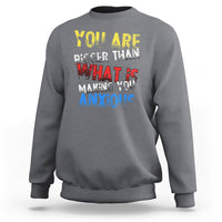 Charcoal gray crewneck sweatshirt with colorful front slogan graphic