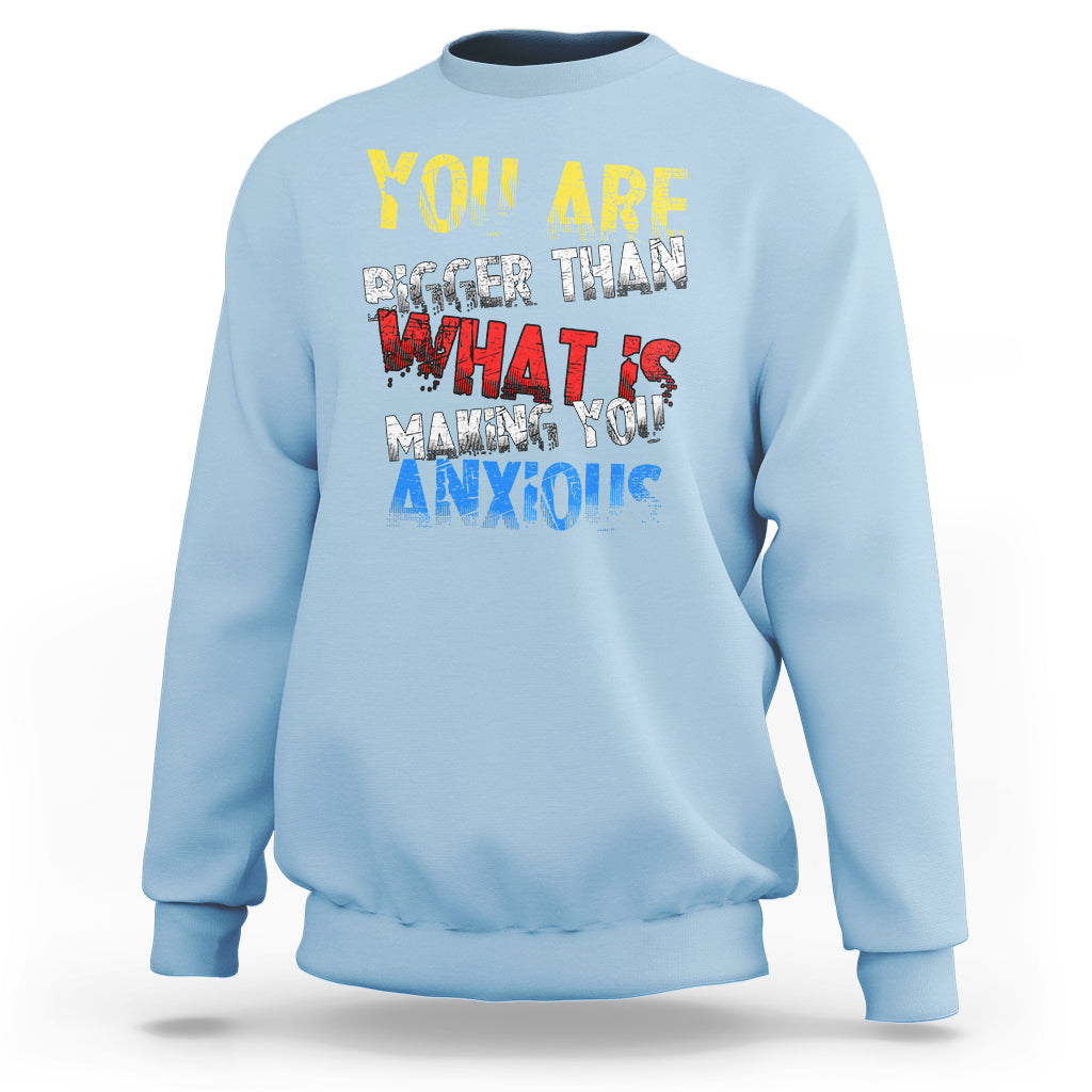 Light blue crewneck sweatshirt with colorful front slogan graphic