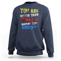 Navy crewneck sweatshirt with colorful front slogan graphic