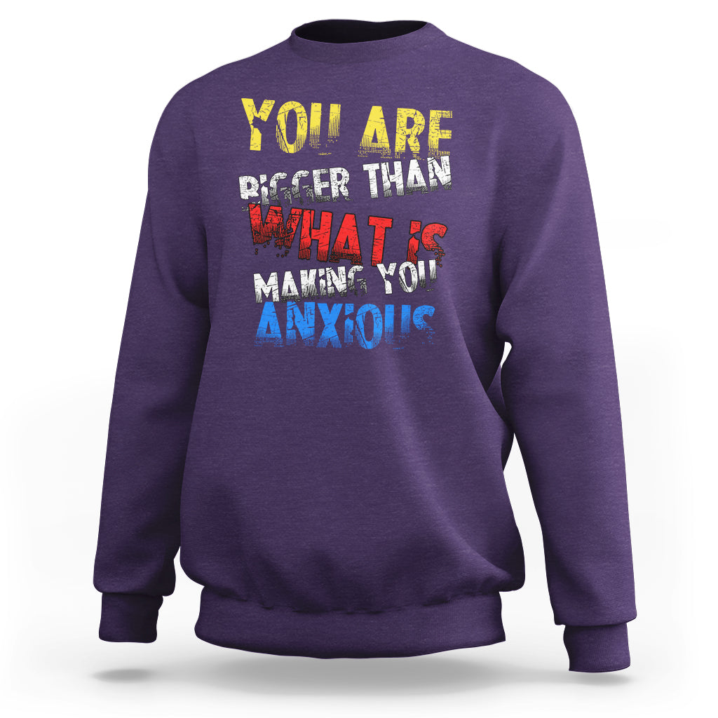 Purple crewneck sweatshirt with colorful front slogan graphic