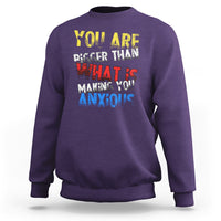 Purple crewneck sweatshirt with colorful front slogan graphic