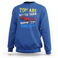 Royal blue crewneck sweatshirt with colorful front slogan graphic
