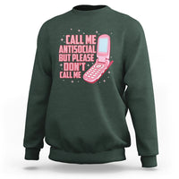 Introvert sweatshirt in dark forest green with front graphic text and pink microphone illustration
