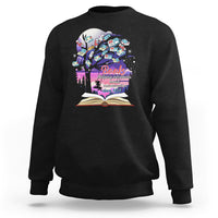 Black crewneck sweatshirt with colorful book graphic and open book print