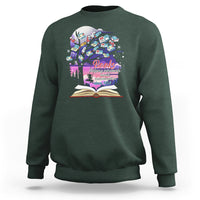 Dark green crewneck sweatshirt with colorful book graphic and open book print