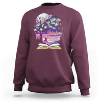 Maroon crewneck sweatshirt with colorful book graphic and open book print