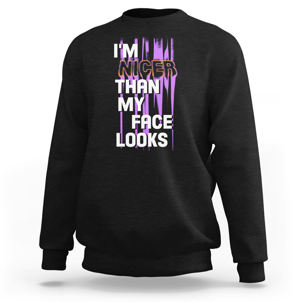 Black crewneck sweatshirt with front graphic text: “I’m nicer than my face looks”