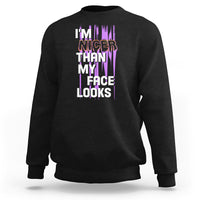 Black crewneck sweatshirt with front graphic text: “I’m nicer than my face looks”