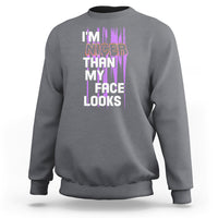 Charcoal crewneck sweatshirt with front graphic text: “I’m nicer than my face looks”