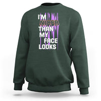 Dark forest green crewneck sweatshirt with front graphic text: “I’m nicer than my face looks”