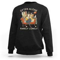 Black crewneck sweatshirt with graphic text 'OFTEN ALONE' and 'RARELY LONELY'.