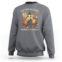 Charcoal crewneck sweatshirt with graphic text 'OFTEN ALONE' and 'RARELY LONELY'.