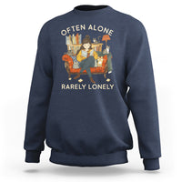Navy crewneck sweatshirt with graphic text 'OFTEN ALONE' and 'RARELY LONELY'.
