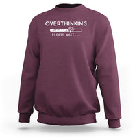 Maroon sweatshirt with 'OVERTHINKING' 'PLEASE WAIT...' graphic on chest, crew neck